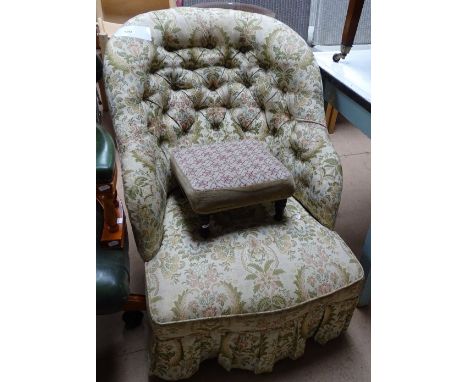 A Victorian button back upholstered armchair, and a footstool.