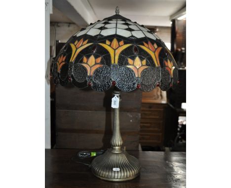 A table lamp with large Tiffany style shade.
