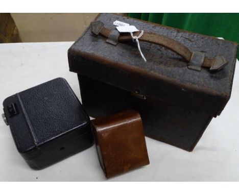 A Pathescope baby cine camera, a light meter in leather case.