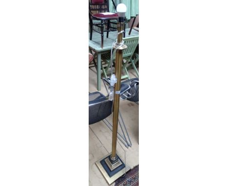 A contemporary designer matt gilt standard lamp on plinth base, height 140cm.