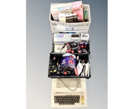 An Atari 800 computer box and two crates containing Atari computer systems, joy sticks, programme recorder, tape deck, discs 