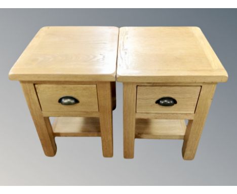 A pair of contemporary oak lamp tables fitted drawers