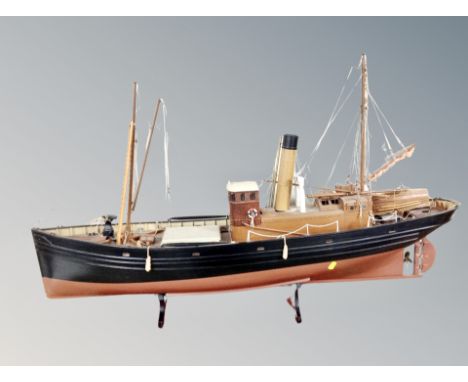 A wooden model of a trawler on stand 