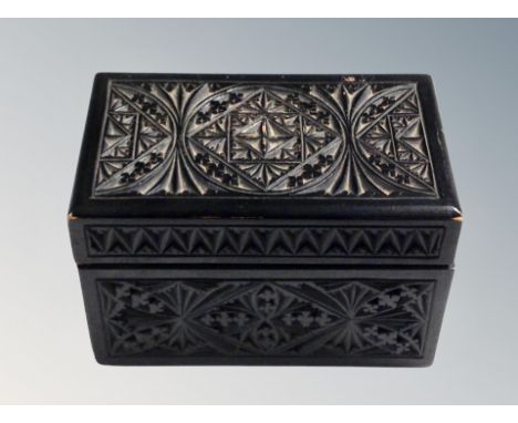 A carved oak playing card box