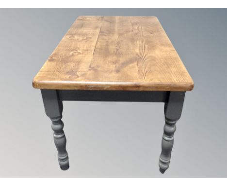 A pine farmhouse kitchen table on painted legs plus four ladder back chairs 