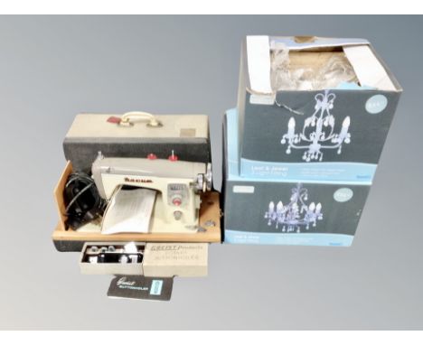 A 20th century Novem electric sewing machine in case together with two leaf and jewel three-way light fittings, boxed 