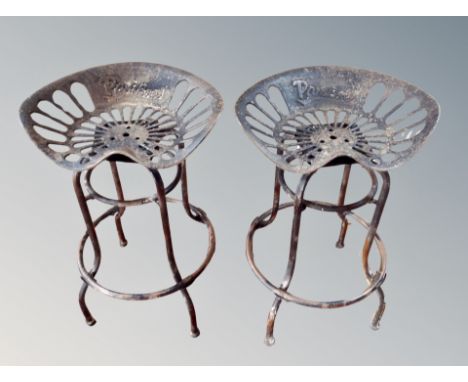 A pair of contemporary tractor seat bar stools 