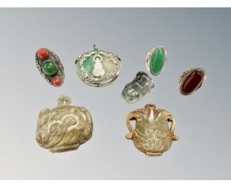 A Chinese jade and white metal circular disk pendant, three hard stone inset rings, carved jade toad and similar scent bottle