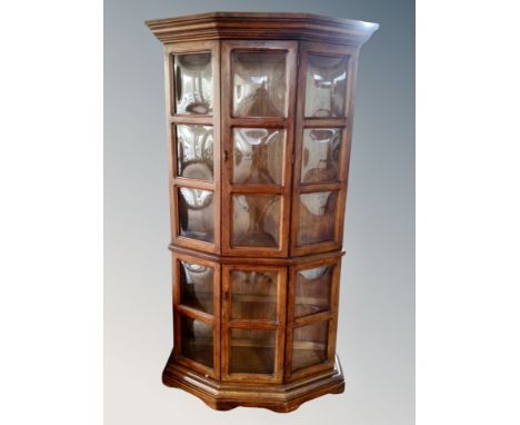 A shaped double display cabinet with glass panel doors in oak finish CONDITION REPORT: No shelves 