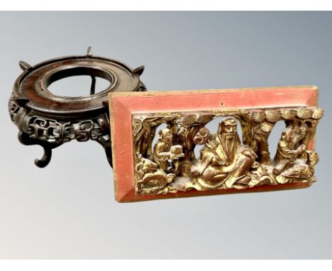 A Chinese painted and gilt wood panel depicting figures, width 27cm, and a carved hardwood vase stand (2)