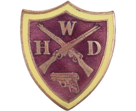 WW2 Women’s Home Defence Badge, brass and enamel shield type badge with the centre having crossed rifles and a pistol, WHD wi
