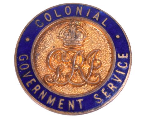 WW1 Colonial Government Service Lapel Badge, blue enamel circle with wording within, central crowned GRI cipher, lapel fittin