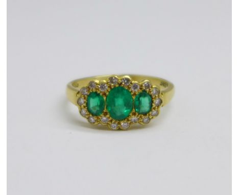 An 18ct gold, emerald and diamond triple cluster ring, 3.3g, N, (centre emerald approximately 4mm x 5 to 6mm) 