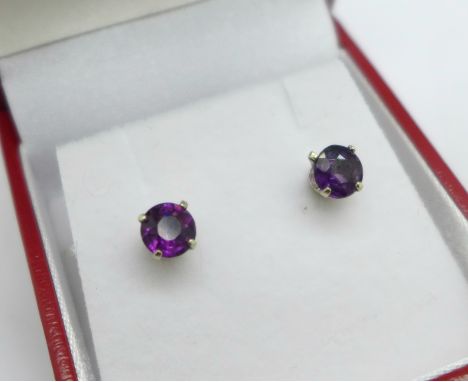 A pair of 14ct white gold amethyst stud earrings, marked 14k on stems, and fitted with 9ct scrolls 