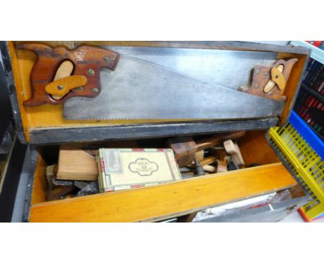 A collection of tools in a pine tool chest including two Henry Disston, U.S.A., saws, Record 4½ and 078 planes, drill bits, b