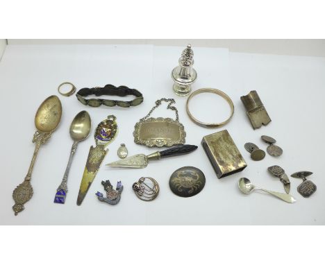 A collection of silver items, etc., including a Brandy label, a pepper, a matchbox holder, a P &amp; O bookmark, three spoons