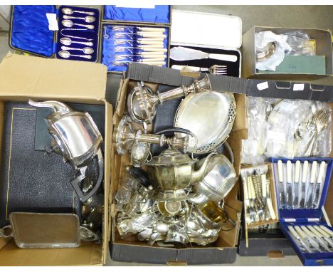 A three piece silver plated tea service, a pair of silver plate on copper candlesticks and two boxes of silver plate and flat