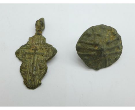A Viking cross and cloak button, found in Russia 