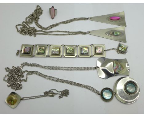 1970's stainless steel jewellery, five pendants and chains, two marked Jason Designs, Sheffield, a bracelet and a ring, H, so