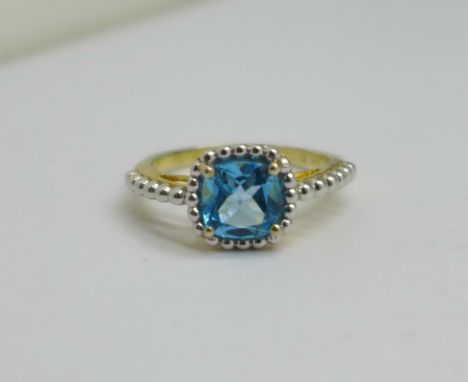 A silver gilt and blue topaz solitaire ring, Q 