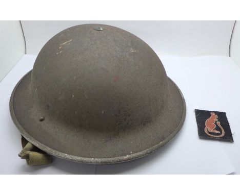 A British WWII helmet and a Desert Rat uniform patch 