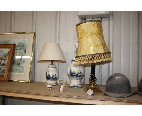 Two Valsan pottery table lamps, each decorated with moored boats; and a brass table lamp and shade 