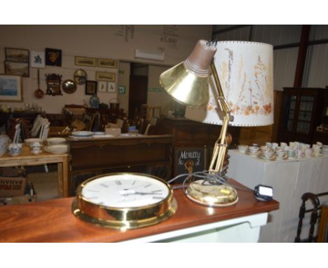 A brass angle poise style lamp; and a modern wall clock