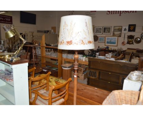 A carved mahogany standard lamp and shade 