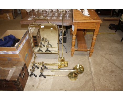 A brass and mirrored glass fire screen; together with a quantity of brass fire irons, chestnut roaster, pair of fire dogs, an