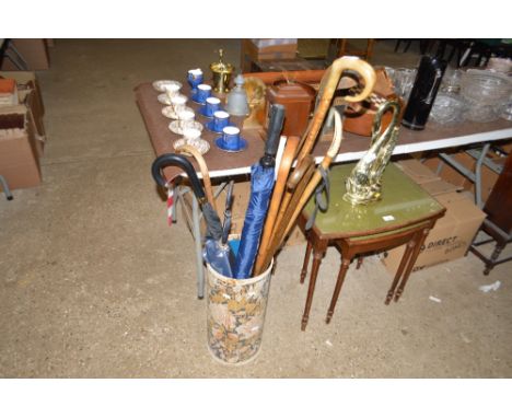 A stick stand and contents of walking sticks, golf clubs, umbrellas etc.