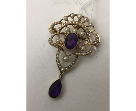 A 15ct gold brooch, circa 1900 set with an oval amethyst and half pearl set entwined design