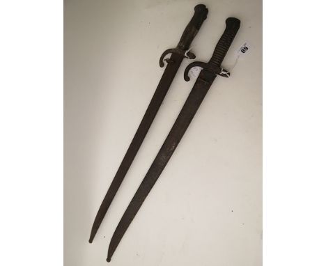 A 19th century bayonet in metal scabbard, marked Culle Avril 1871 to top edge of blade and a similar French circa 1900, bayon