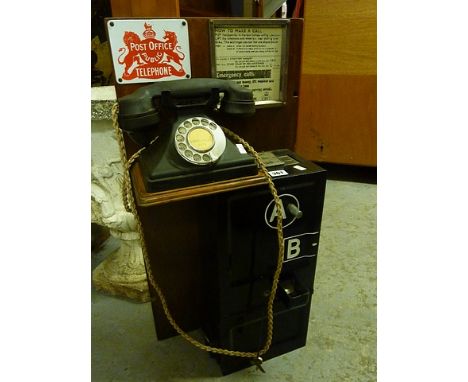 A black cased telephone 164 67 mounted as a vintage pay phone, the back board with Post Office public telephone and 'How to M