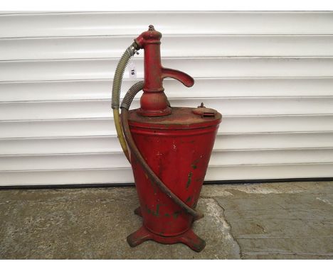 A red vintage oil dispensing pump