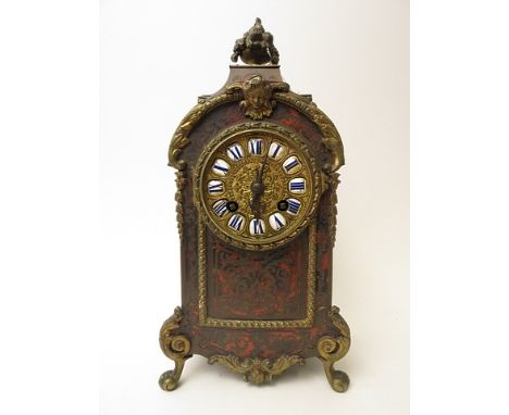 A late 19th century French tortoiseshell and brass inlaid boulle mantle clock with gilt brass dial having blue Roman numerals