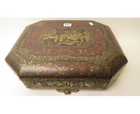 19th century black and red lacquered Chinese gaming box of octagonal form on four carved paw feet, interior fitted with 7 lid