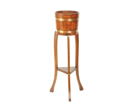 OAK AND COPPER BOUND PLANTER ON THREE SPLAYED LEGS WITH UNDERSHELF.HEIGHT: 36 INCHES DIAMETER: 10 INCHES SLIGHT MARK TO UNDER