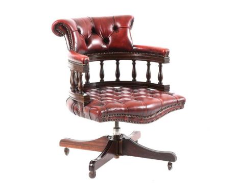 RED DEEP BUTTON LEATHER CAPTAIN'S CHAIR ON MAHOGANY BASE, WITH CASTORS HEIGHT: 33 INCHES WIDTH: 23 INCHES DEPTH: 24 INCHES GO