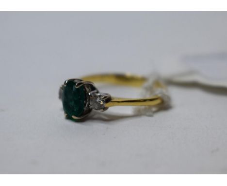 An 18ct gold, emerald and diamond three stone ring, approx. ring size K