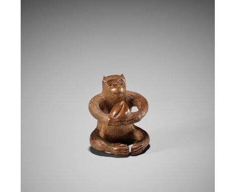 AN AMUSING WOOD NETSUKE OF A MONKEY WITH PEACHUnsigned Japan, late 19th century, Meiji period (1868-1912)The monkey with its 