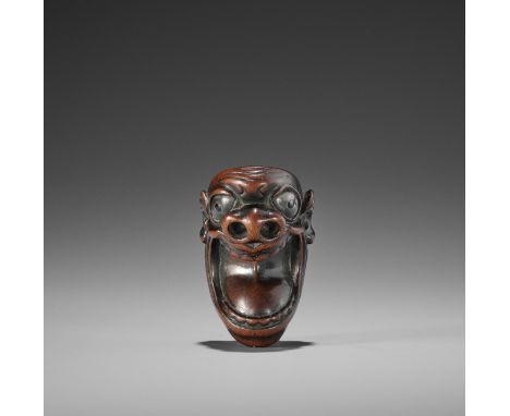 HOGEN: A RARE WOOD MASK NETSUKESigned Hogen 法元Japan, early 19th century, Edo period (1615-1868)The expressively carved mask d