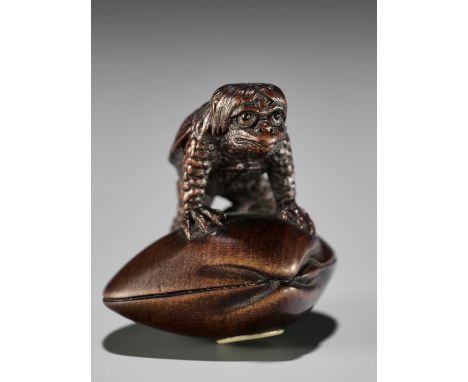 JUZAN: A FINE WOOD NETSUKE OF A KAPPA ON HAMAGURI CLAMBy Juzan, signed Juzan 壽山Japan, Edo (Tokyo), second half of 19th centur