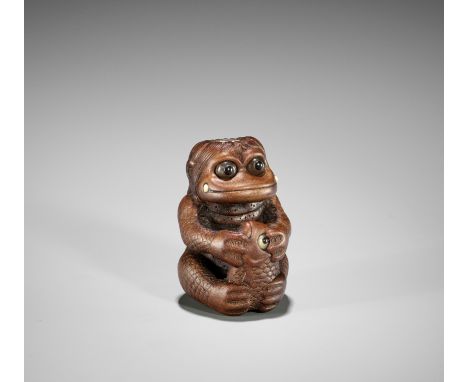 AN AMUSING INLAID CONTEMPORARY WOOD NETSUKE OF A KAPPA WITH FISHUnsignedJapan, 20th centuryThe kappa seated holding a large f