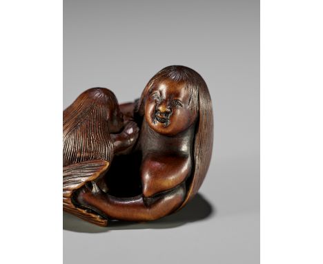 HOSEN: A FINE AND RARE WOOD NETSUKE OF A NINGYO (MERMAID) NURSING HER CHILDBy Hosen, signed Hosen 芳仙Japan, early 19th century