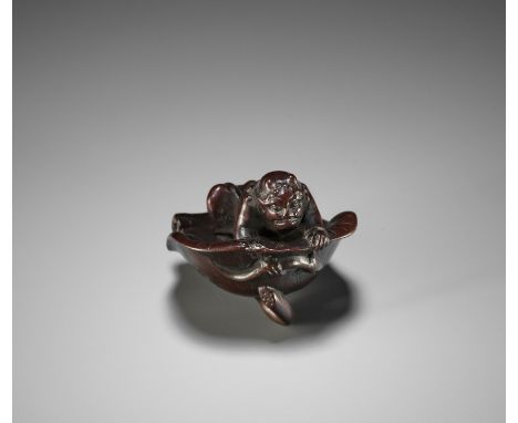 JURAKU: A FINE WOOD NETSUKE OF AN ONI FISHING INSIDE A LOTUS LEAFBy Juraku, signed Juraku 壽乐 and kakihanJapan, Edo (Tokyo), m