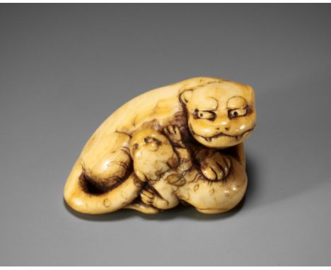 A SUPERB KYOTO SCHOOL IVORY NETSUKE OF A TIGER WITH CUBUnsignedJapan, Kyoto, 18th century, Edo period (1615-1868)A remarkably