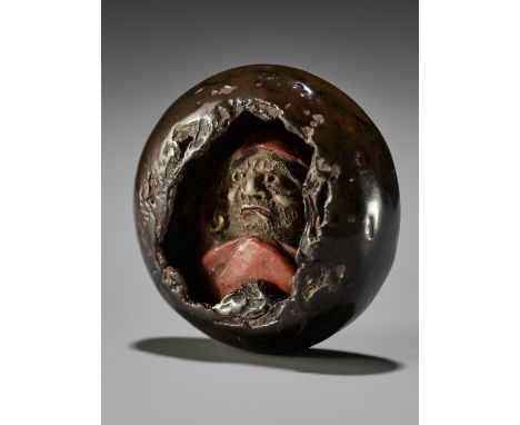 KAN: A RARE LACQUER AND POTTERY-INLAID MANJU NETSUKE OF DARUMA INSIDE A CAVEBy a follower of Ogawa Haritsu (Ritsuo, 1663-1747