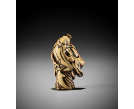 A POWERFUL STAG ANTLER NETSUKE OF KAN'UUnsignedJapan, 18th century, Edo period (1615-1868)The war general standing and holdin