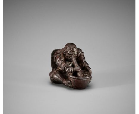 AN AMUSING PLUM WOOD SHUNGA NETSUKE OF A KONOHA TENGU GRINDING MISOUnsignedJapan, Edo (Tokyo), early 19th century, Edo period