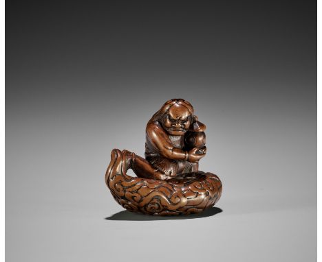 A POWERFUL EDO SCHOOL WOOD NETSUKE OF AN ONI STEALING A STUPAUnsignedJapan, Edo (Tokyo), late 18th century, Edo period (1615-
